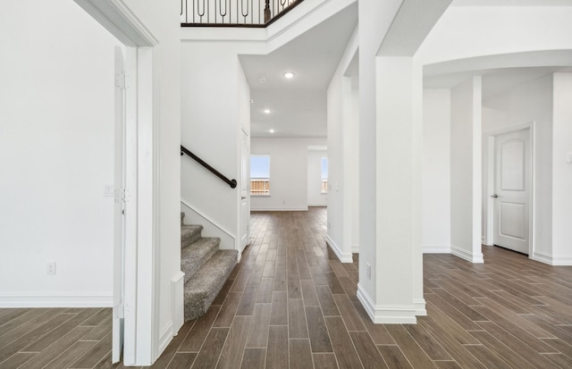 foyer featuring dark hardwood / wood-style floors and a towering ceiling