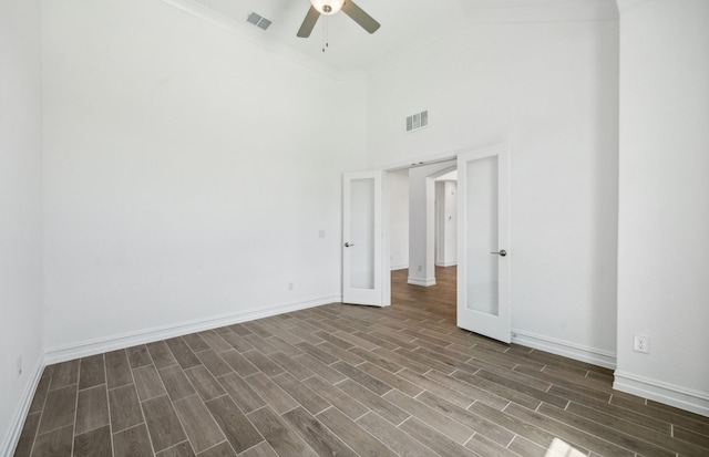 unfurnished room with ceiling fan, french doors, dark hardwood / wood-style flooring, high vaulted ceiling, and crown molding