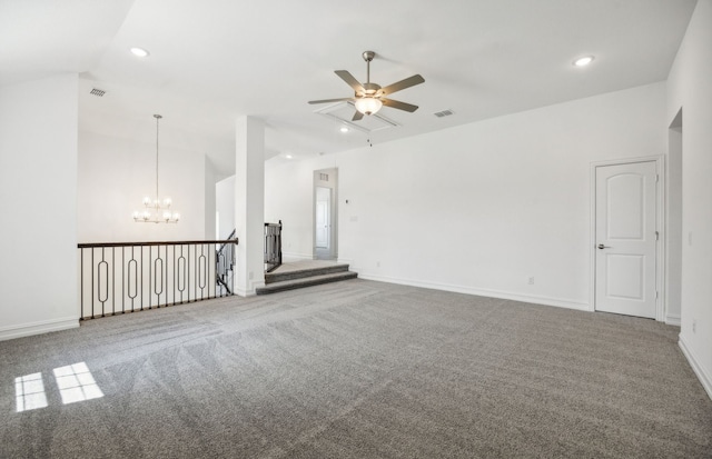 carpeted spare room featuring ceiling fan with notable chandelier and lofted ceiling