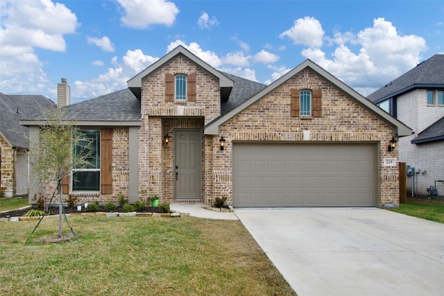 view of front of property featuring a front lawn and a garage