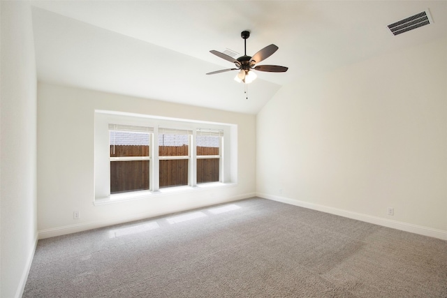 carpeted spare room featuring ceiling fan and lofted ceiling