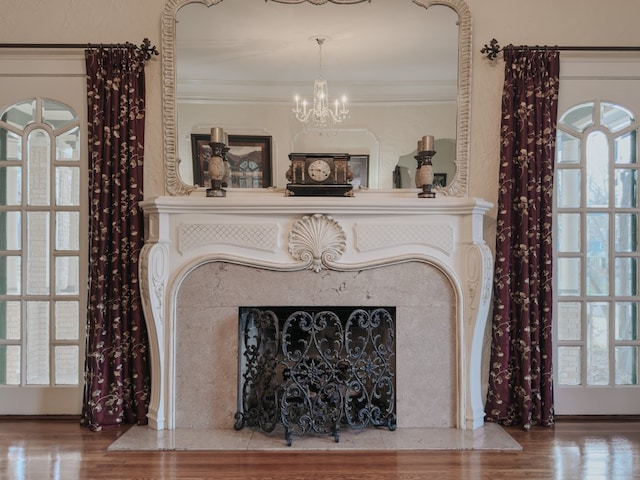 interior details with ornamental molding, a chandelier, and wood-type flooring