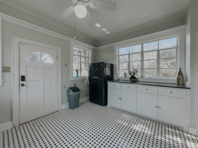 laundry room featuring ceiling fan and light tile floors