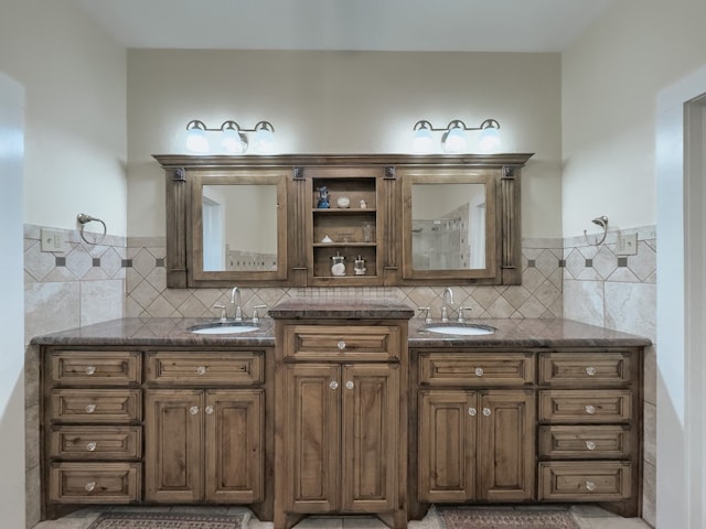 bathroom featuring dual sinks, backsplash, and vanity with extensive cabinet space