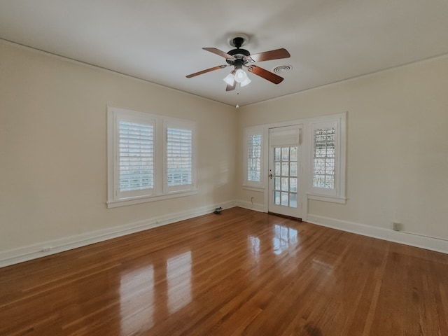 empty room with ceiling fan and dark wood-type flooring