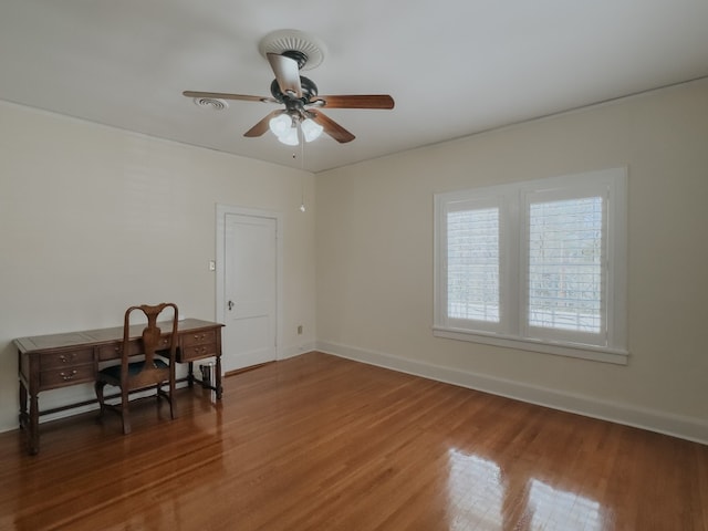 spare room with ceiling fan and dark hardwood / wood-style flooring