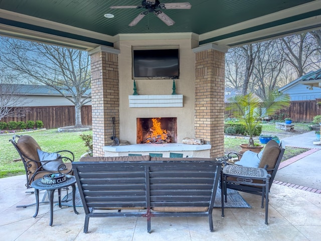 view of terrace featuring an outdoor fireplace and ceiling fan