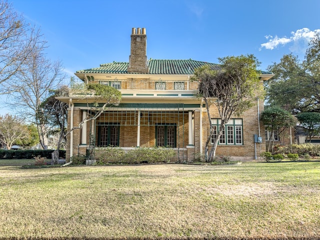 back of property with a lawn