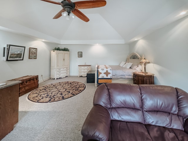 bedroom featuring light carpet, a raised ceiling, ceiling fan, and lofted ceiling