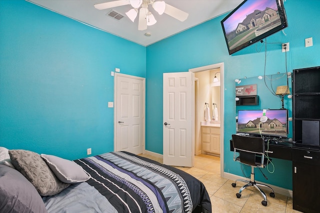 tiled bedroom featuring ceiling fan and ensuite bath