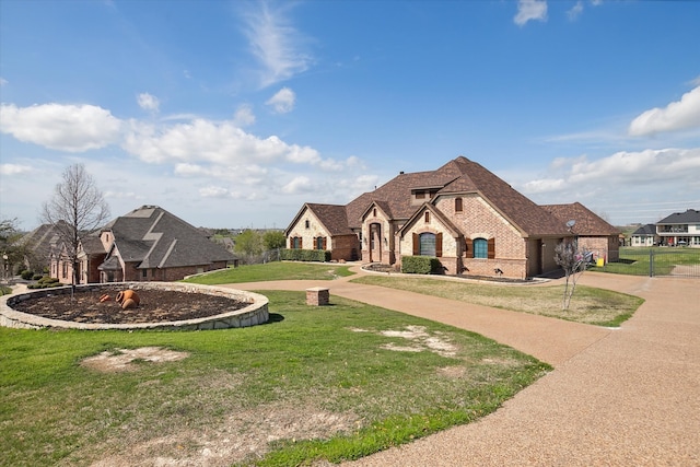 french country home featuring a front lawn