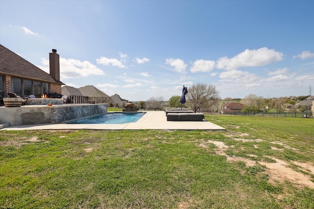 view of pool with pool water feature, a patio, and a yard