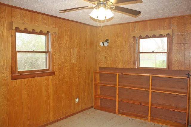 empty room with wood walls and ceiling fan