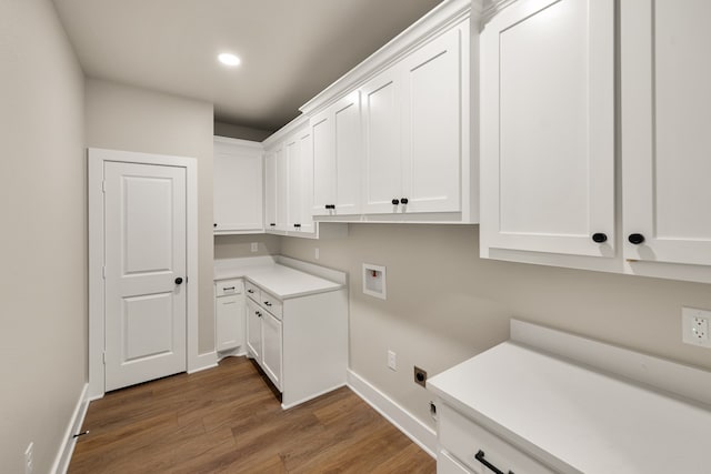 clothes washing area featuring hookup for a washing machine, cabinets, and dark hardwood / wood-style floors