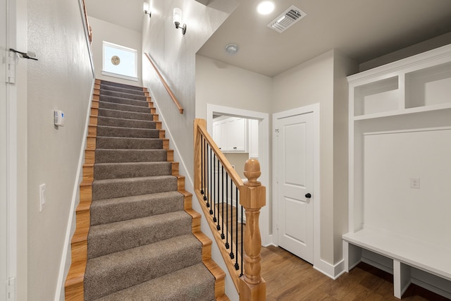 stairs featuring hardwood / wood-style floors