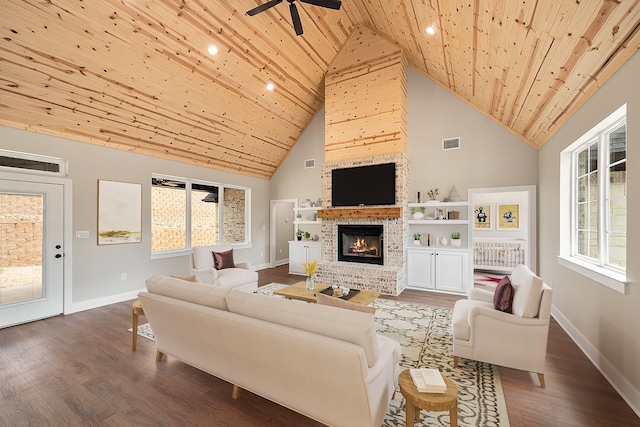 living room featuring high vaulted ceiling, hardwood / wood-style flooring, wooden ceiling, and a brick fireplace