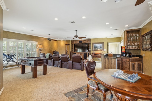 dining space featuring crown molding, carpet floors, and ceiling fan