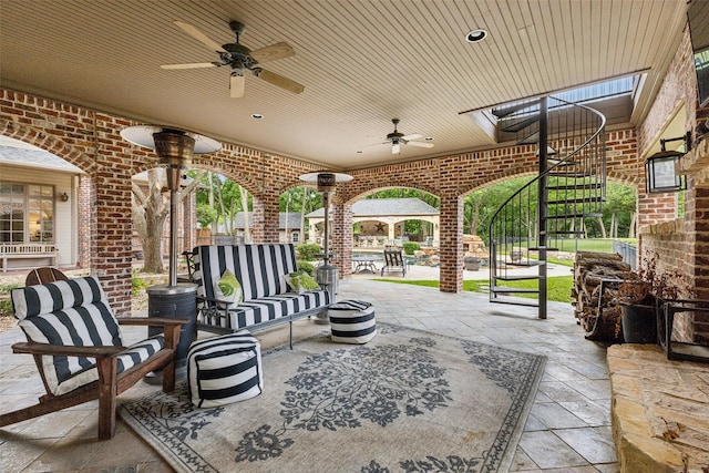 view of patio / terrace with an outdoor living space and ceiling fan