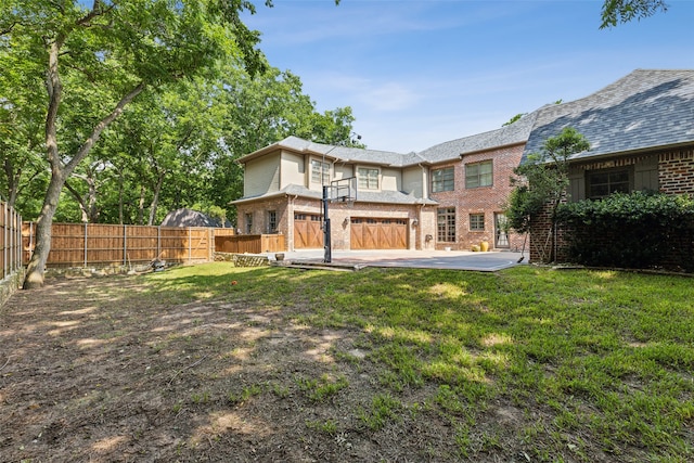 back of house with a patio and a yard