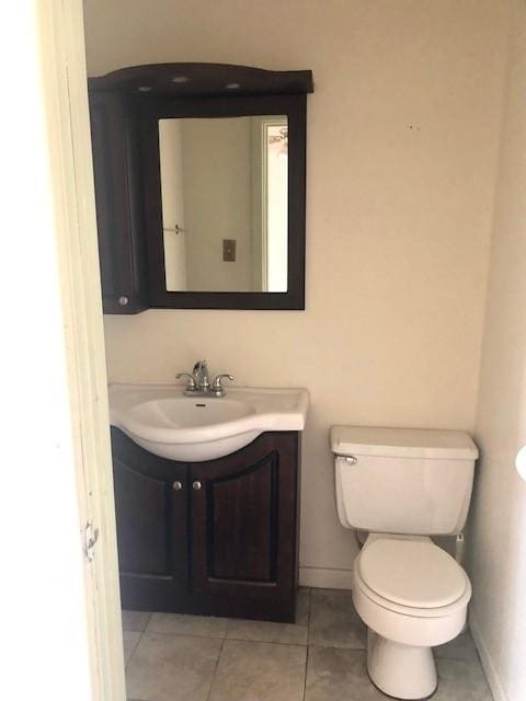 bathroom with vanity, toilet, and tile patterned flooring