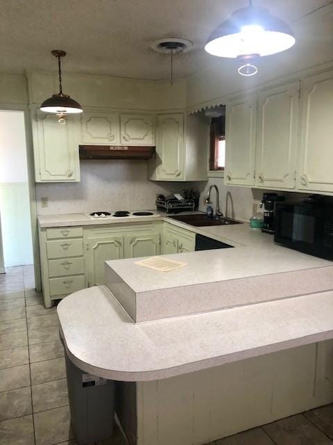 kitchen featuring sink, light tile patterned floors, decorative backsplash, decorative light fixtures, and kitchen peninsula