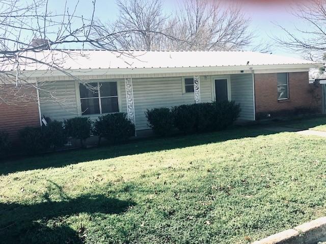 rear view of house featuring a yard