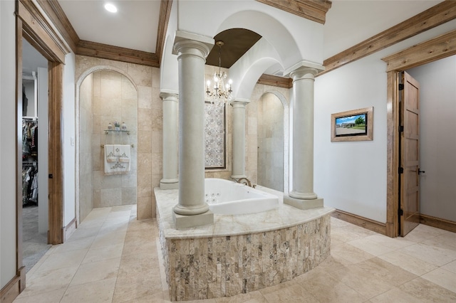 bathroom with a relaxing tiled bath, a notable chandelier, tile flooring, and decorative columns