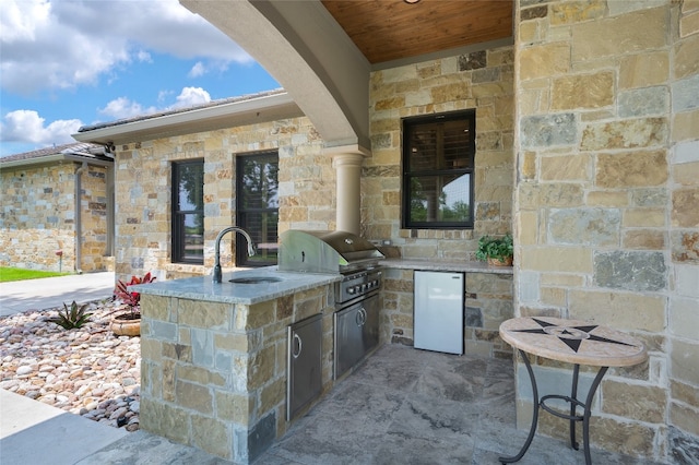 view of terrace featuring area for grilling, an outdoor kitchen, and sink