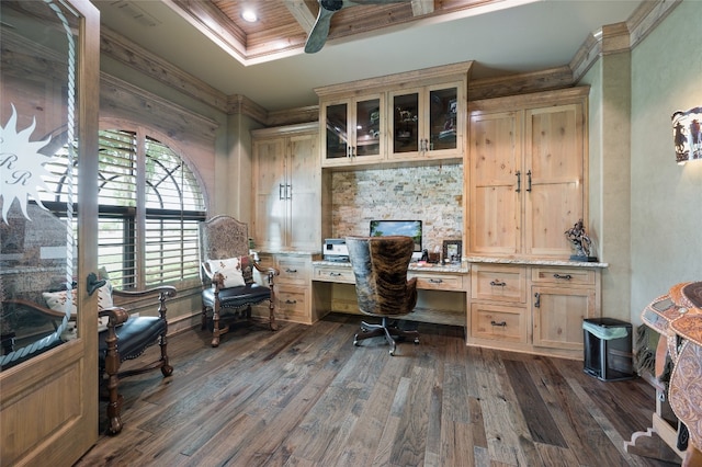 home office featuring a fireplace, ceiling fan, ornamental molding, built in desk, and dark hardwood / wood-style floors