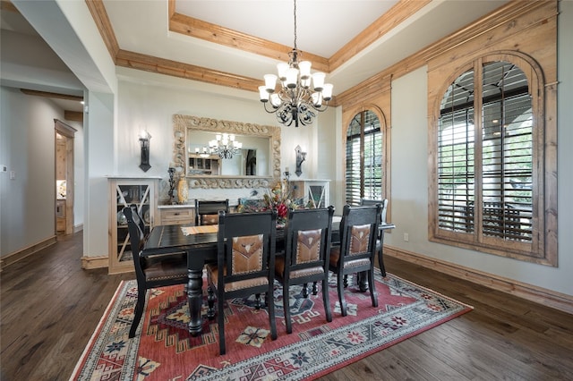 dining room with an inviting chandelier, crown molding, dark wood-type flooring, and a raised ceiling