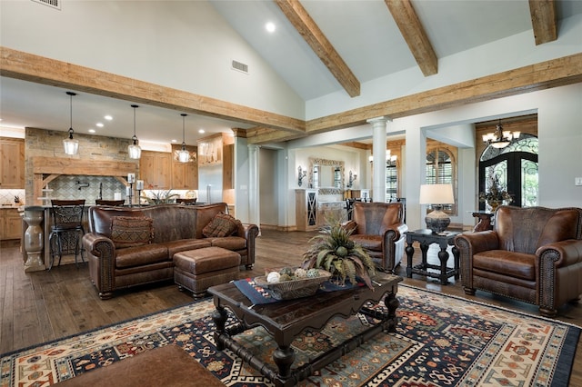 living room featuring decorative columns, an inviting chandelier, high vaulted ceiling, beam ceiling, and dark hardwood / wood-style flooring