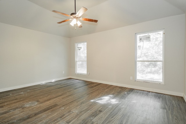 spare room with ceiling fan, dark wood-type flooring, and a healthy amount of sunlight