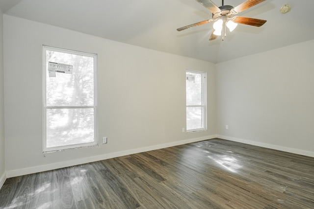 unfurnished room with ceiling fan, a wealth of natural light, and dark hardwood / wood-style floors