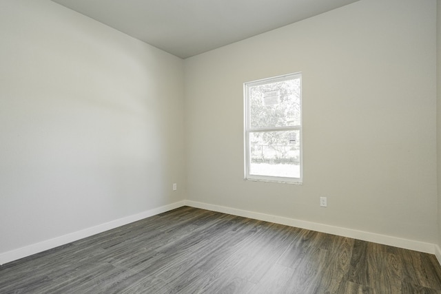 unfurnished room featuring dark hardwood / wood-style flooring