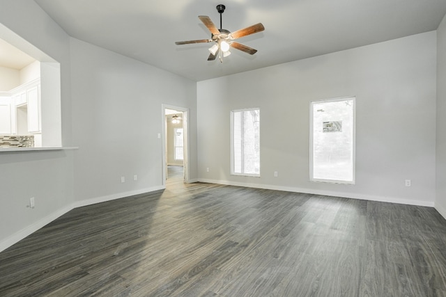 empty room with dark hardwood / wood-style floors and ceiling fan