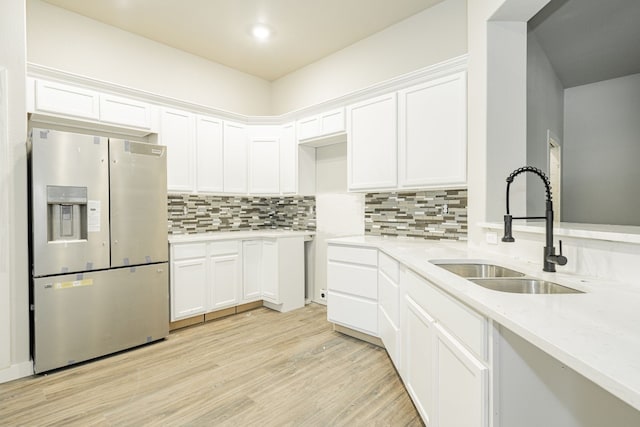 kitchen featuring light hardwood / wood-style flooring, sink, white cabinetry, and stainless steel fridge with ice dispenser