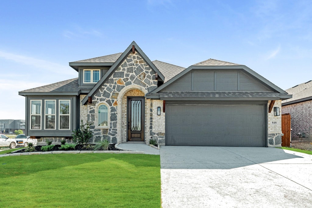 view of front facade with a front lawn and a garage