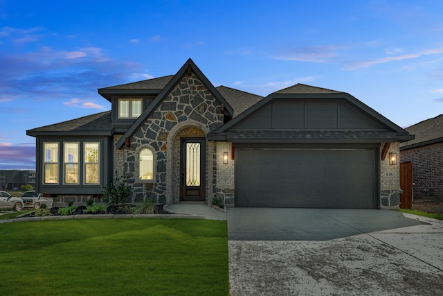 view of front of home featuring a garage and a yard