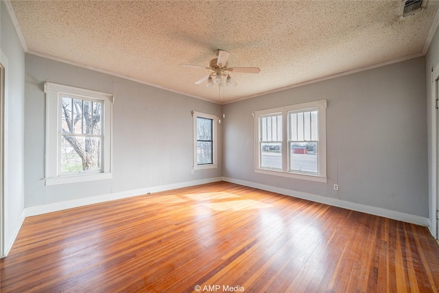1832 Commercial Ave, Anson, TX 79501 - empty room with crown molding, hardwood / wood-style floors, and a textured ceiling