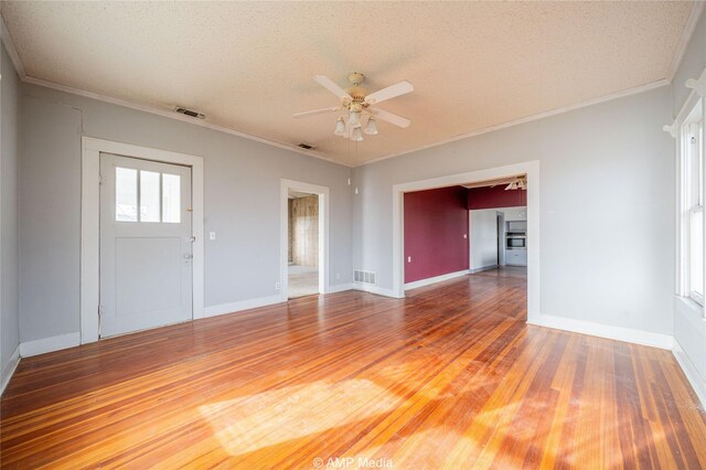 1832 Commercial Ave, Anson, TX 79501 - interior space featuring hardwood / wood-style flooring, ornamental molding, a textured ceiling, and ceiling fan