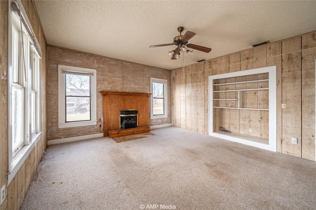 1832 Commercial Ave, Anson, TX 79501 - unfurnished living room featuring ceiling fan, light carpet, and a textured ceiling