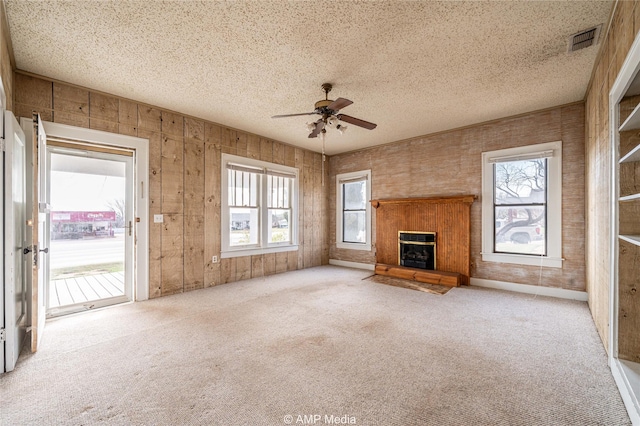 1832 Commercial Ave, Anson, TX 79501 - unfurnished living room featuring light carpet, ceiling fan, and a textured ceiling