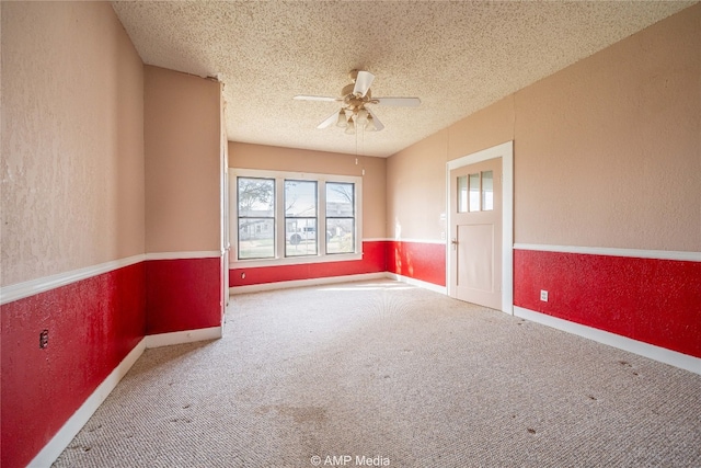 1832 Commercial Ave, Anson, TX 79501 - carpeted empty room featuring ceiling fan and a textured ceiling