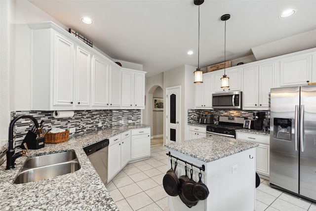 kitchen featuring white cabinetry, light tile patterned flooring, light stone countertops, and stainless steel appliances