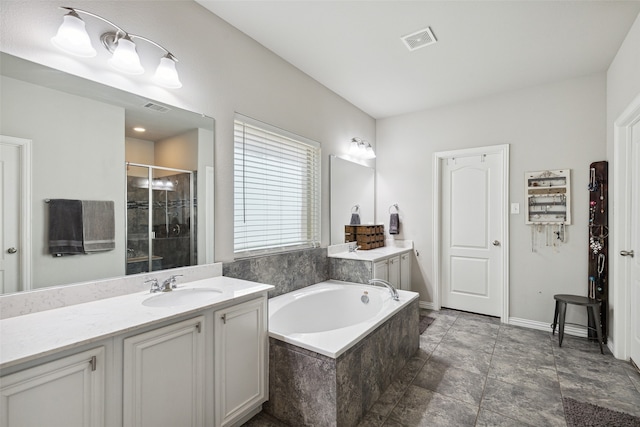 bathroom featuring vanity and independent shower and bath