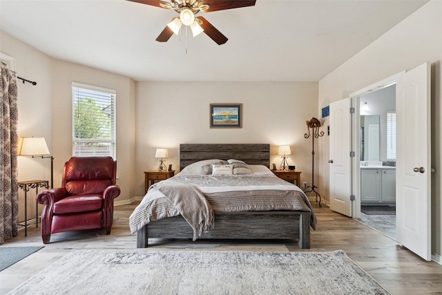 bedroom featuring ceiling fan, connected bathroom, and light hardwood / wood-style floors