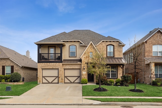 view of front of house with a garage, a balcony, and a front yard