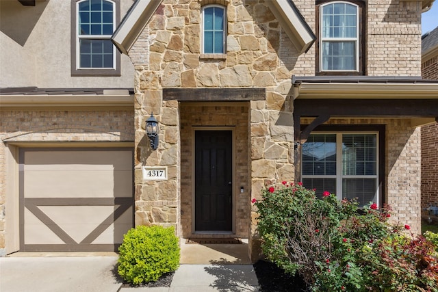 doorway to property featuring a garage