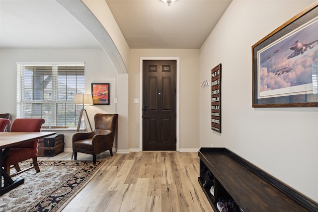 dining area with light hardwood / wood-style floors and a notable chandelier