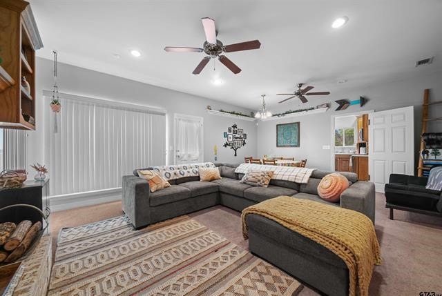 living room with carpet flooring and ceiling fan